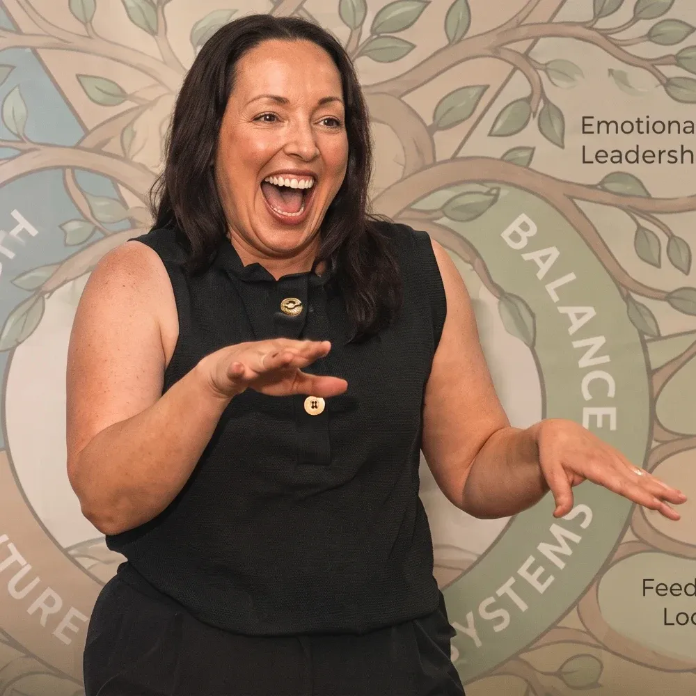 Marie Donnelly teaching in front of the Inner Power S.Y.S.T.E.M. wheel